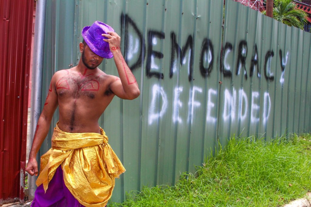 Democracy Defended Fit twentysomething man in costume with hat.